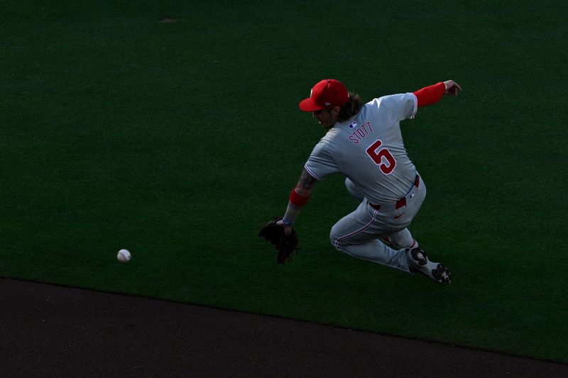 Apr 27, 2024; San Diego, California, USA; Philadelphia Phillies second baseman Bryson Stott (5) fields a ground ball during the first inning against the San Diego Padres at Petco Park. Mandatory Credit: Orlando Ramirez-USA TODAY Sports