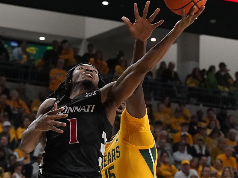 Jan 13, 2024; Waco, Texas, USA; Cincinnati Bearcats guard Day Day Thomas (1) drives past Baylor Bears forward Josh Ojianwuna (15) during the first half at Paul and Alejandra Foster Pavilion. Mandatory Credit: Raymond Carlin III-USA TODAY Sports