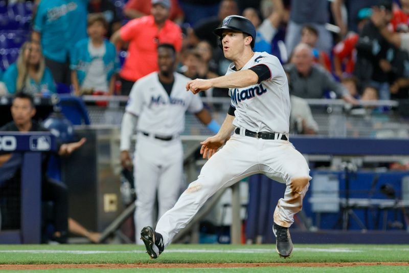 Jun 4, 2023; Miami, Florida, USA; Miami Marlins shortstop Joey Wendle (18) stops running on his way to home plate against the Oakland Athletics during the eighth inning at loanDepot Park. Mandatory Credit: Sam Navarro-USA TODAY Sports