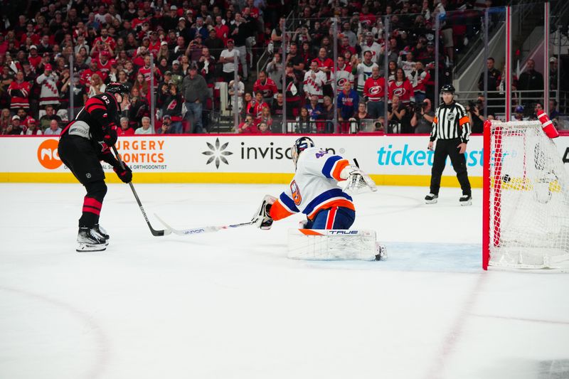 Apr 30, 2024; Raleigh, North Carolina, USA; Carolina Hurricanes center Evgeny Kuznetsov (92) scores a penalty shot goal against New York Islanders goaltender Semyon Varlamov (40) during the first period in game five of the first round of the 2024 Stanley Cup Playoffs at PNC Arena. Mandatory Credit: James Guillory-USA TODAY Sports