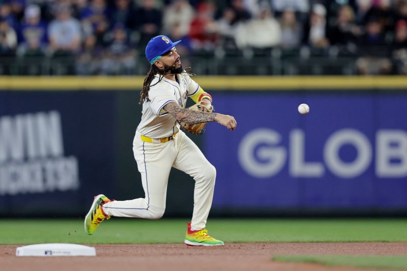 Jun 2, 2024; Seattle, Washington, USA;  Seattle Mariners shortstop J.P. Crawford (3) throws to first base during the first inning against the Los Angeles Angels at T-Mobile Park. Mandatory Credit: John Froschauer-USA TODAY Sports