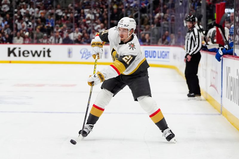 Apr 8, 2025; Denver, Colorado, USA; Vegas Golden Knights center Brett Howden (21) shoots the puck in the first period against the Colorado Avalanche at Ball Arena. Mandatory Credit: Ron Chenoy-Imagn Images