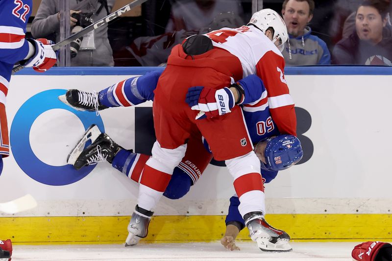 Nov 29, 2023; New York, New York, USA; Detroit Red Wings center Klim Kostin (24) hits New York Rangers left wing Will Cuylle (50) during the third period at Madison Square Garden. Mandatory Credit: Brad Penner-USA TODAY Sports