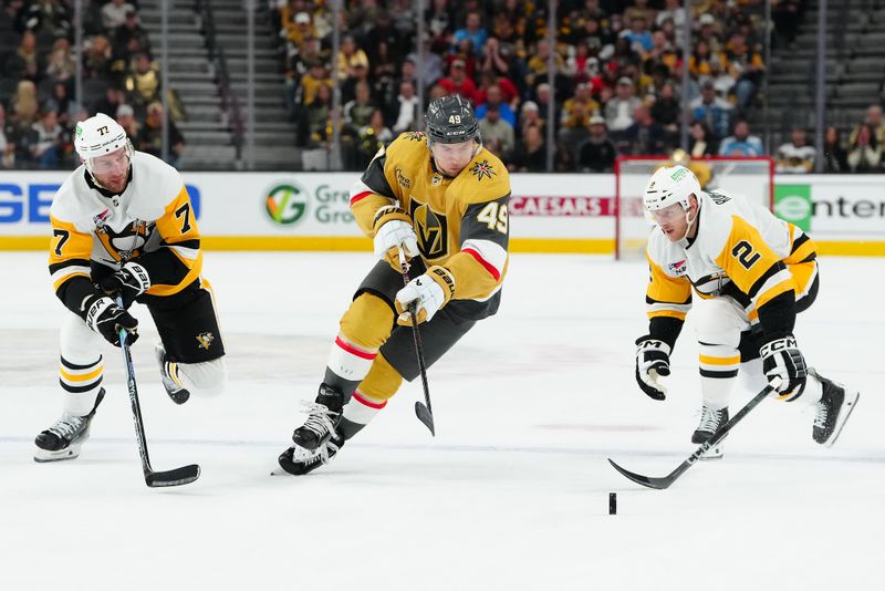 Jan 20, 2024; Las Vegas, Nevada, USA; Vegas Golden Knights center Ivan Barbashev (49) controls the puck between Pittsburgh Penguins center Jeff Carter (77) and Pittsburgh Penguins defenseman Chad Ruhwedel (2) during the first period at T-Mobile Arena. Mandatory Credit: Stephen R. Sylvanie-USA TODAY Sports