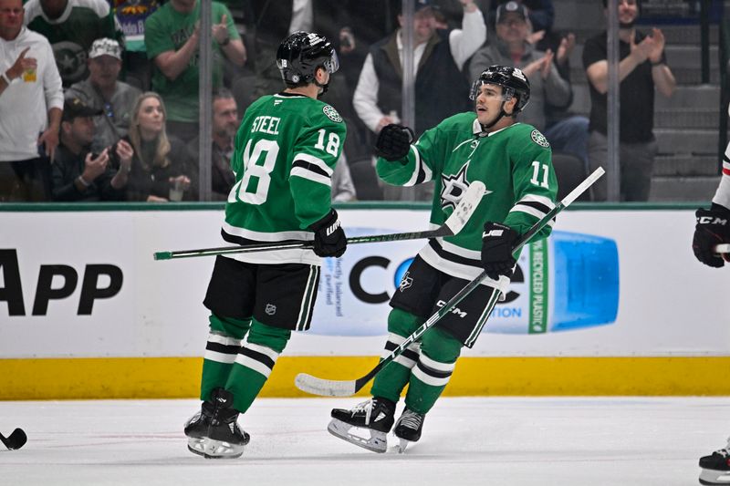 Nov 7, 2024; Dallas, Texas, USA; Dallas Stars center Sam Steel (18) and center Logan Stankoven (11) celebrates a goal scored by Steel against the Chicago Blackhawks during the first period at the American Airlines Center. Mandatory Credit: Jerome Miron-Imagn Images