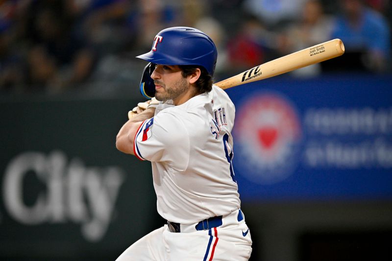 May 2, 2024; Arlington, Texas, USA; Texas Rangers third baseman Josh Smith (8) hits a double against the Washington Nationals during the eighth inning at Globe Life Field. Mandatory Credit: Jerome Miron-USA TODAY Sports