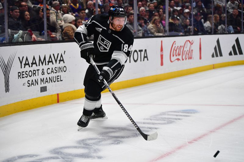 Dec 30, 2023; Los Angeles, California, USA; Los Angeles Kings defenseman Vladislav Gavrikov (84) moves the puck against the Edmonton Oilers during the third period at Crypto.com Arena. Mandatory Credit: Gary A. Vasquez-USA TODAY Sports