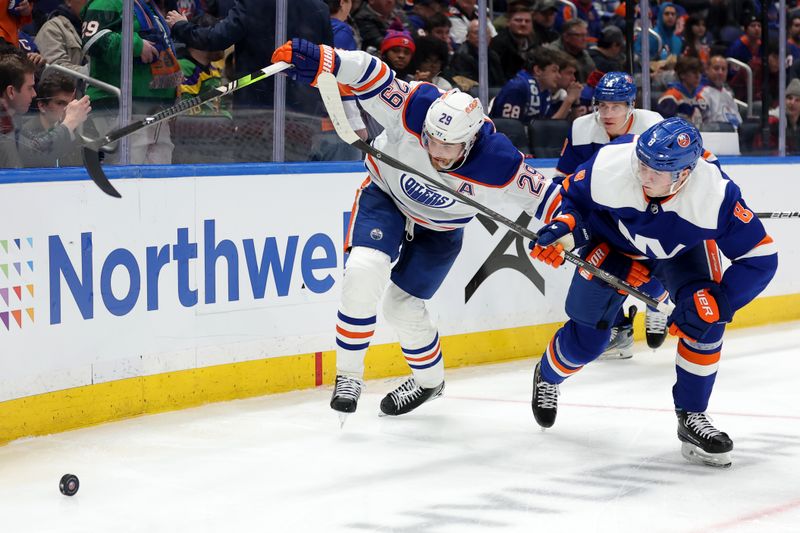 Dec 19, 2023; Elmont, New York, USA; Edmonton Oilers center Leon Draisaitl (29) fights for the puck against New York Islanders defenseman Noah Dobson (8) during the third period at UBS Arena. Mandatory Credit: Brad Penner-USA TODAY Sports