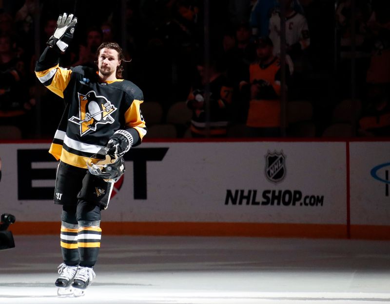 Apr 15, 2024; Pittsburgh, Pennsylvania, USA;  Pittsburgh Penguins defenseman Erik Karlsson (65) waves to the crowd after being named a star of the game against the Nashville Predators at PPG Paints Arena. The Penguins won 4-2. Mandatory Credit: Charles LeClaire-USA TODAY Sports