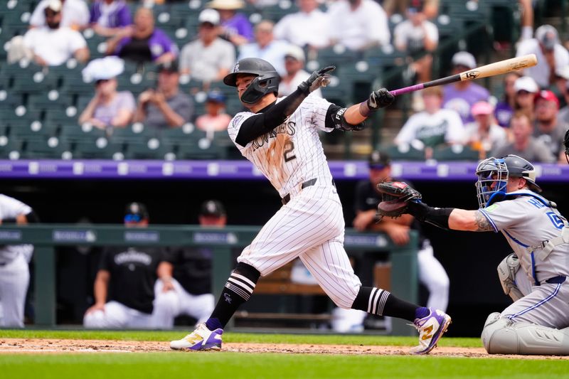Aug 6, 2025; Denver, Colorado, USA; Colorado Rockies outfielder Tyler Freeman (2) doubles in the fifth inning against the Toronto Blue Jays at Coors Field. Mandatory Credit: Ron Chenoy-Imagn Images