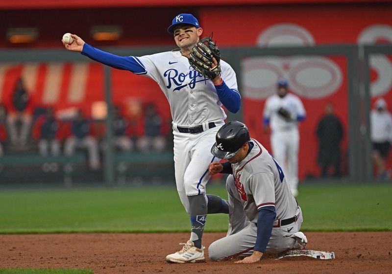 Apr 15, 2023; Kansas City, Missouri, USA;  Kansas City Royals second baseman Michael Massey (19) throws to first base over Atlanta Braves first baseman Matt Olson (28)during the third inning at Kauffman Stadium. Mandatory Credit: Peter Aiken-USA TODAY Sports