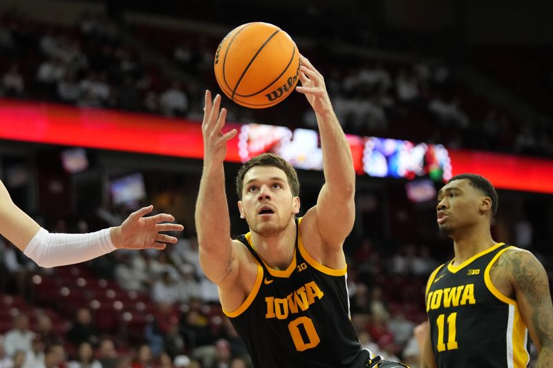 Feb 22, 2023; Madison, Wisconsin, USA; Iowa Hawkeyes forward Filip Rebraca (0) rebounds the ball during the first half against the Wisconsin Badgers at the Kohl Center. Mandatory Credit: Kayla Wolf-USA TODAY Sports