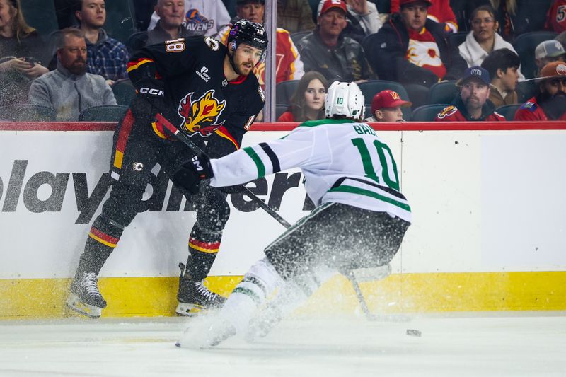 Mar 3, 2026; Calgary, Alberta, CAN; Calgary Flames center John Beecher (18) controls the puck against Dallas Stars center Oskar Bäck (10) during the first period at Scotiabank Saddledome. Mandatory Credit: Sergei Belski-Imagn Images