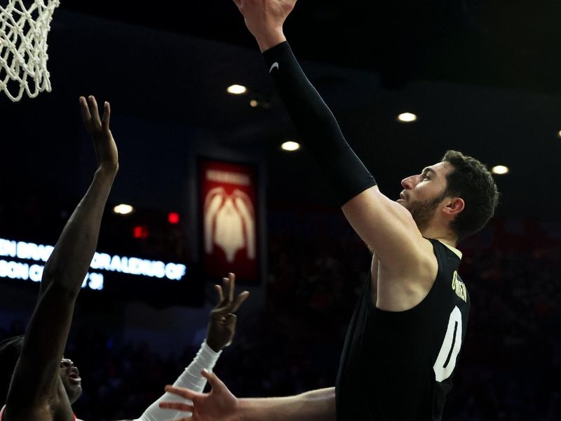 Jan 4, 2024; Tucson, Arizona, USA; Colorado Buffaloes guard Luke O'Brien (0) shoots a basket against Arizona Wildcats center Oumar Ballo (11) during the first half at McKale Center. Mandatory Credit: Zachary BonDurant-USA TODAY Sports