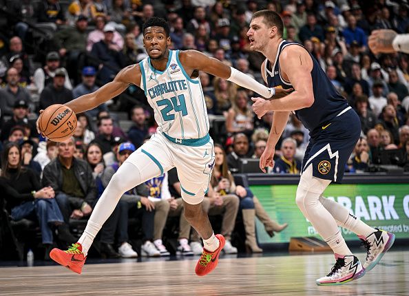 DENVER, CO - JANUARY 1: Nikola Jokic (15) of the Denver Nuggets fouls Brandon Miller (24) of the Charlotte Hornets during the first quarter at Ball Arena in Denver on Monday, January 1, 2024. (Photo by AAron Ontiveroz/The Denver Post)