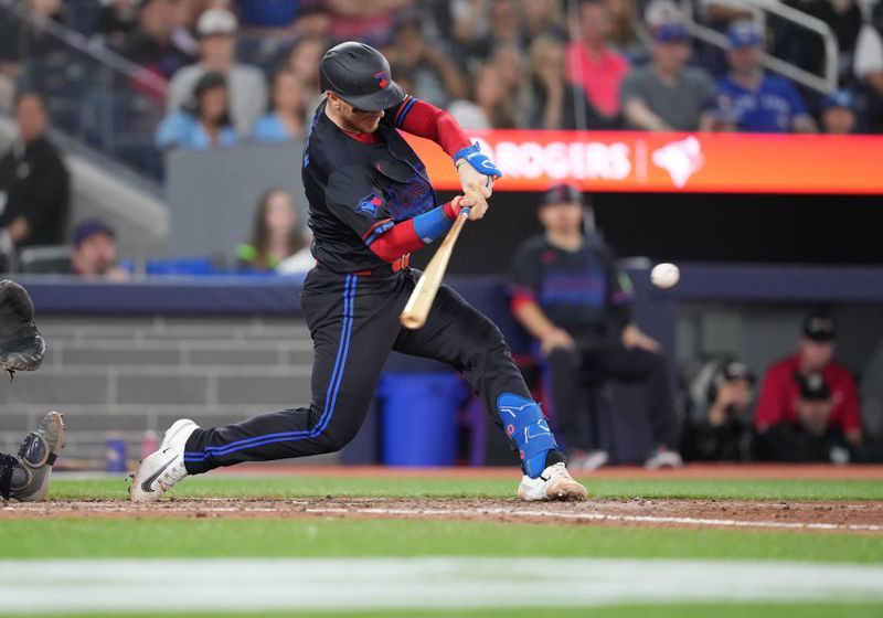 Jun 28, 2024; Toronto, Ontario, CAN; Toronto Blue Jays catcher Danny Jansen (9) hits a single against the New York Yankees during the eighth inning at Rogers Centre. Mandatory Credit: Nick Turchiaro-USA TODAY Sports