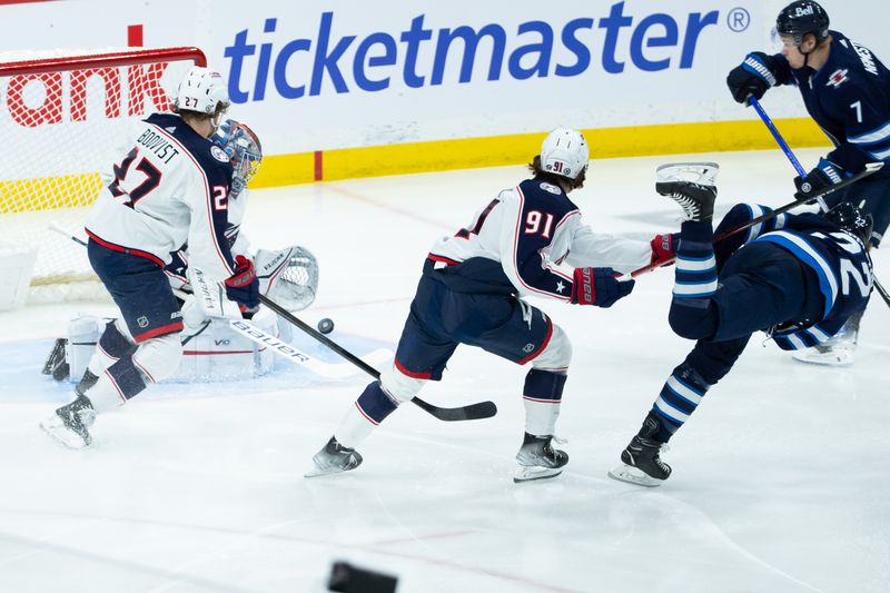 Jan 9, 2024; Winnipeg, Manitoba, CAN; Columbus Blue Jackets goalie Daniil Tarasov (40) makes a save on a shot by Winnipeg Jets forward Mason Appleton (22) during the third period at Canada Life Centre. Mandatory Credit: Terrence Lee-USA TODAY Sports