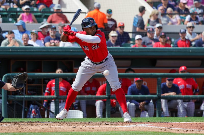 Mar 4, 2024; Lakeland, Florida, USA; Boston Red Sox shortstop Pablo Reyes (19) dodges an inside pitch during the second inning against the Detroit Tigers at Publix Field at Joker Marchant Stadium. Mandatory Credit: Mike Watters-USA TODAY Sports