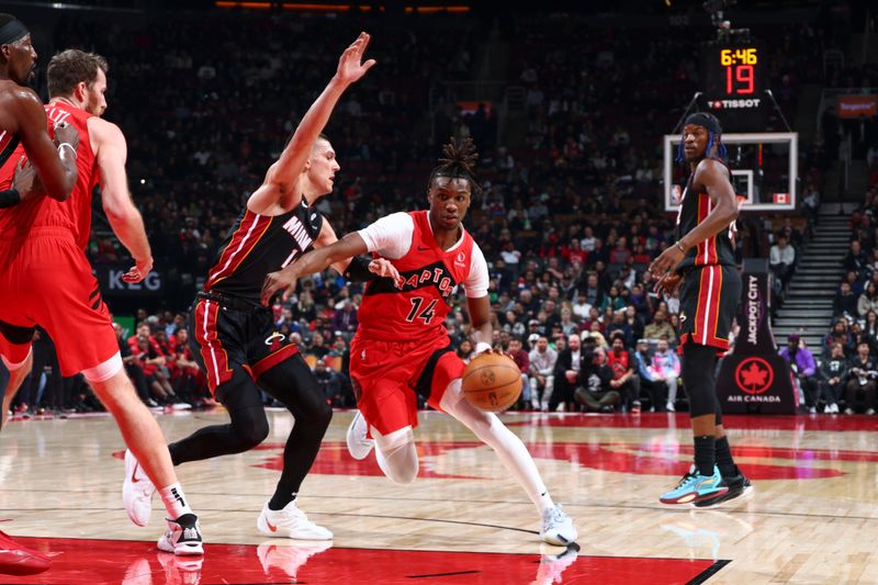 TORONTO, CANADA - DECEMBER 01:  Ja'Kobe Walter #14 of the Toronto Raptors drives to the basket during the game against the Miami Heat on December 1, 2024 at the Scotiabank Arena in Toronto, Ontario, Canada.  NOTE TO USER: User expressly acknowledges and agrees that, by downloading and or using this Photograph, user is consenting to the terms and conditions of the Getty Images License Agreement.  Mandatory Copyright Notice: Copyright 2024 NBAE (Photo by Vaughn Ridley/NBAE via Getty Images)