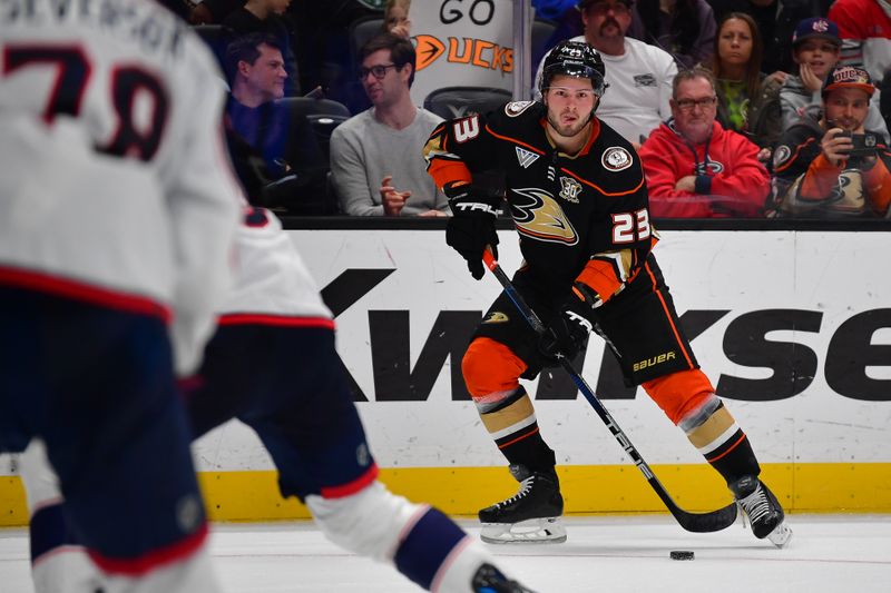 Feb 21, 2024; Anaheim, California, USA; Anaheim Ducks center Mason McTavish (23) controls the puck against the Columbus Blue Jackets during the third period at Honda Center. Mandatory Credit: Gary A. Vasquez-USA TODAY Sports