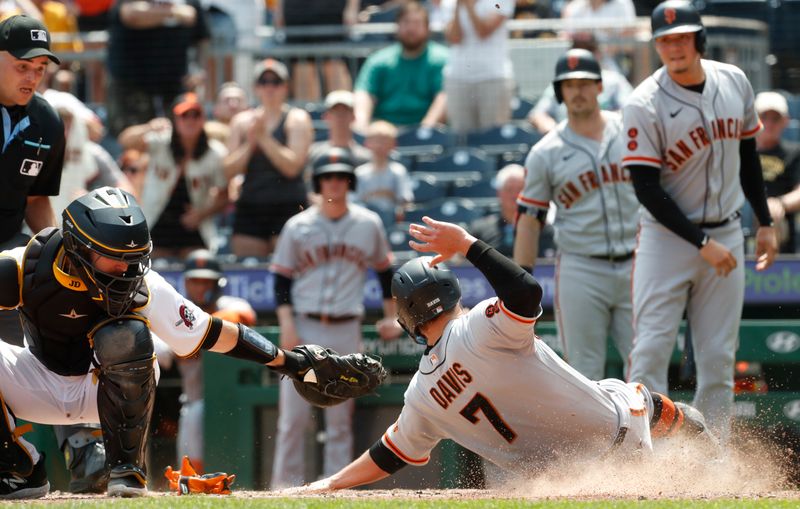 Jul 16, 2023; Pittsburgh, Pennsylvania, USA;  San Francisco Giants third baseman J.D. Davis (7) slides past the tag attempt of Pittsburgh Pirates catcher Jason Delay (55) to score a run during the tenth inning at PNC Park. Mandatory Credit: Charles LeClaire-USA TODAY Sports