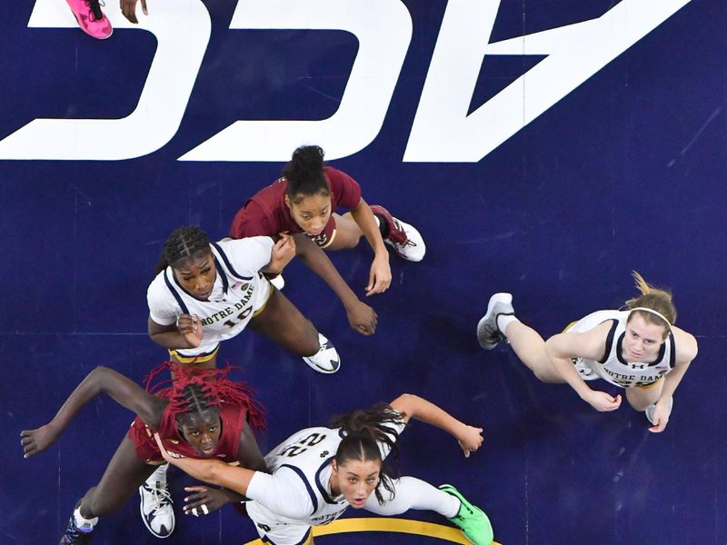 Jan 11, 2024; South Bend, Indiana, USA; Boston College Eagles forward Nene Ndiaye (0) and Notre Dame Fighting Irish forward Kylee Watson (22) ready for the rebound in the second half at the Purcell Pavilion. Mandatory Credit: Matt Cashore-USA TODAY Sports