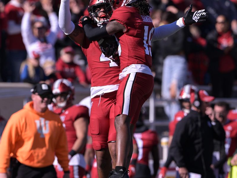 uNov 18, 2023; Bloomington, Indiana, USA; Indiana Hoosiers linebacker Anthony Jones (4) and Indiana Hoosiers defensive back Josh Sanguinetti (19) celebrate an interception against the Michigan State Spartans during the first quarter at Memorial Stadium. Mandatory Credit: Marc Lebryk-USA TODAY Sports