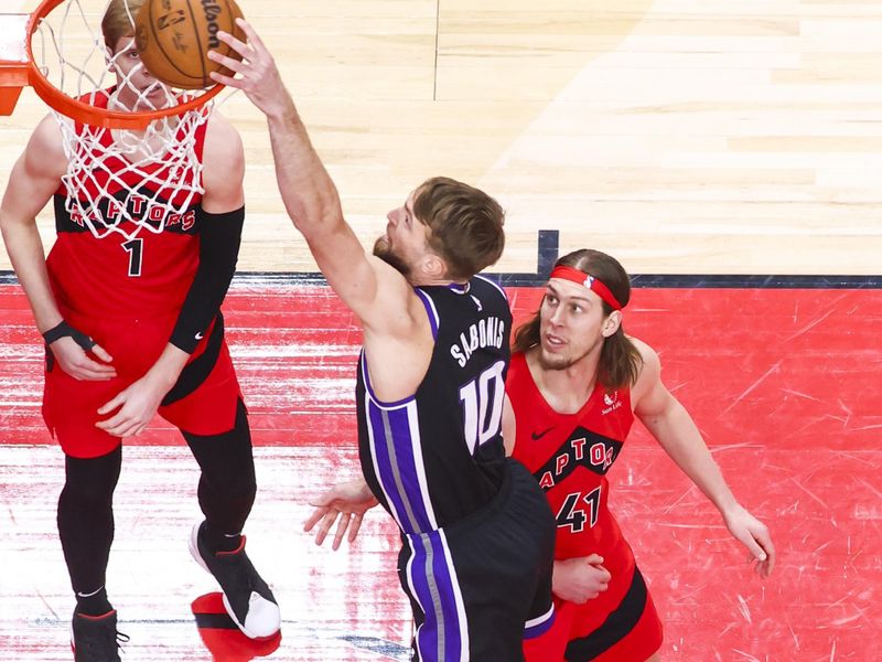 TORONTO, CANADA - MARCH 20: Domantas Sabonis #10 of the Sacramento Kings dunks the ball during the game against the Toronto Raptors on March 20, 2024 at the Scotiabank Arena in Toronto, Ontario, Canada.  NOTE TO USER: User expressly acknowledges and agrees that, by downloading and or using this Photograph, user is consenting to the terms and conditions of the Getty Images License Agreement.  Mandatory Copyright Notice: Copyright 2024 NBAE (Photo by Vaughn Ridley/NBAE via Getty Images)