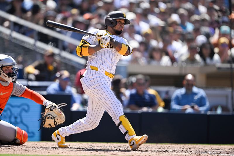 Apr 30, 2025; San Diego, California, USA; San Diego Padres first baseman Luis Arraez (4) hits an RBI triple during the sixth inning against the San Francisco Giants at Petco Park. Mandatory Credit: Denis Poroy-Imagn Images