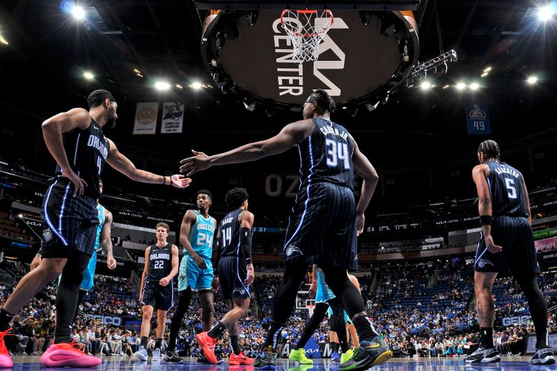 ORLANDO, FL - MARCH 19: Jalen Suggs #4 and Wendell Carter Jr. #34 of the Orlando Magic high five during the game against the Charlotte Hornets on March 19, 2024 at the Kia Center in Orlando, Florida. NOTE TO USER: User expressly acknowledges and agrees that, by downloading and or using this photograph, User is consenting to the terms and conditions of the Getty Images License Agreement. Mandatory Copyright Notice: Copyright 2024 NBAE (Photo by Fernando Medina/NBAE via Getty Images)