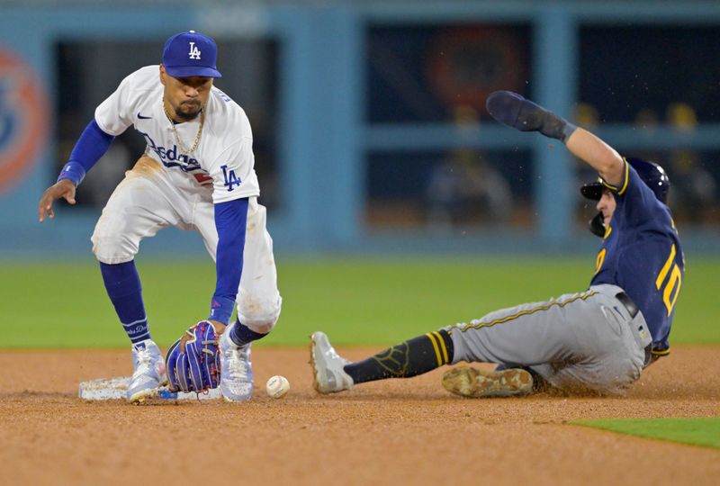 Aug 17, 2023; Los Angeles, California, USA;  Los Angeles Dodgers right fielder Mookie Betts (50) reaches for the ball as Milwaukee Brewers outfielder Sal Frelick (10) steals second in the fourth inning at Dodger Stadium. Mandatory Credit: Jayne Kamin-Oncea-USA TODAY Sports