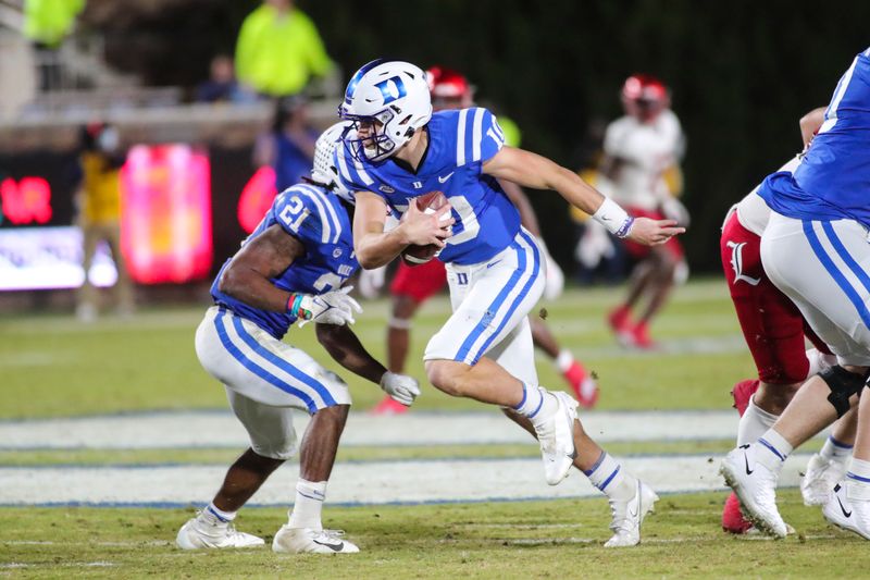 Nov 18, 2021; Durham, North Carolina, USA; Duke Blue Devils quarterback Riley Leonard (10) runs with the ball during the 2nd half of the game against the Louisville Cardinals at Wallace Wade Stadium. Mandatory Credit: Jaylynn Nash-USA TODAY Sports