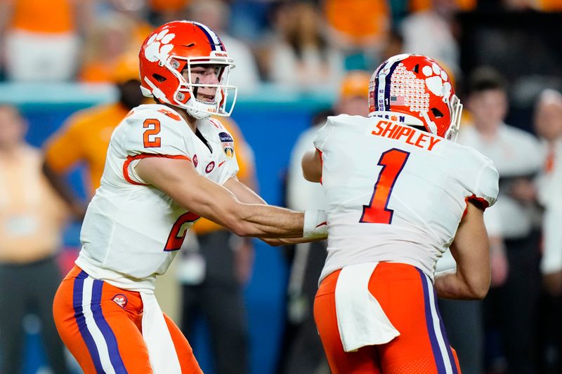 Dec 30, 2022; Miami Gardens, FL, USA; Clemson Tigers quarterback Cade Klubnik (2) hands the ball off to running back Will Shipley (1) during the first half of the 2022 Orange Bowl at Hard Rock Stadium. Mandatory Credit: Rich Storry-USA TODAY Sports