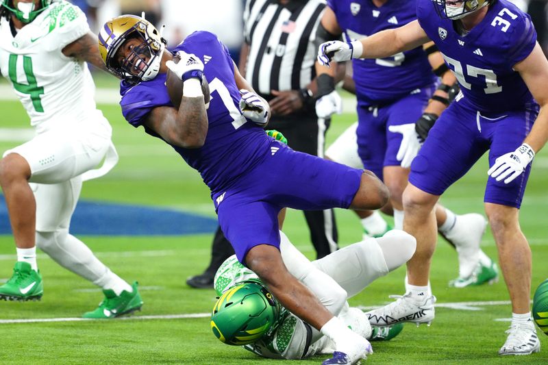 Dec 1, 2023; Las Vegas, NV, USA; Washington Huskies running back Dillon Johnson (7) gains yards against the Oregon Ducks during the first quarter at Allegiant Stadium. Mandatory Credit: Stephen R. Sylvanie-USA TODAY Sports