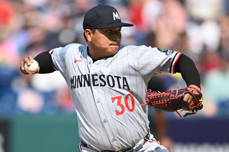 Aug 3, 2025; Cleveland, Ohio, USA; Minnesota Twins relief pitcher Erasmo Ramirez (30) throws a pitch during the ninth inning against the Cleveland Guardians at Progressive Field. Mandatory Credit: Ken Blaze-Imagn Images