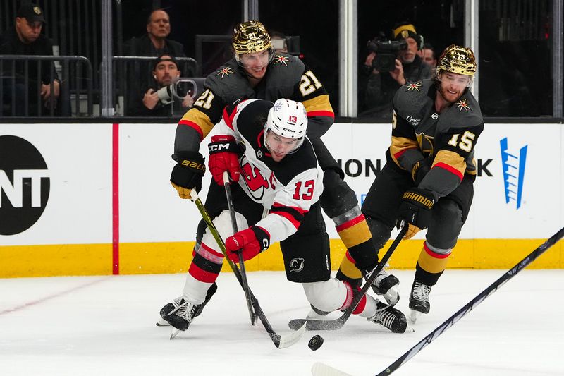 Mar 17, 2024; Las Vegas, Nevada, USA; Vegas Golden Knights center Brett Howden (21) and Vegas Golden Knights defenseman Noah Hanifin (15) break up a scoring chance by New Jersey Devils center Nico Hischier (13) during the second period at T-Mobile Arena. Mandatory Credit: Stephen R. Sylvanie-USA TODAY Sports