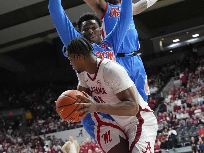 Jan 14, 2025; Tuscaloosa, AL, USA;  Ole Miss defenders stop a drive by Alabama forward Mouhamed Dioubate (10) at Coleman Coliseum. Mandatory Credit: Gary Cosby Jr.-USA TODAY Network via Imagn Images