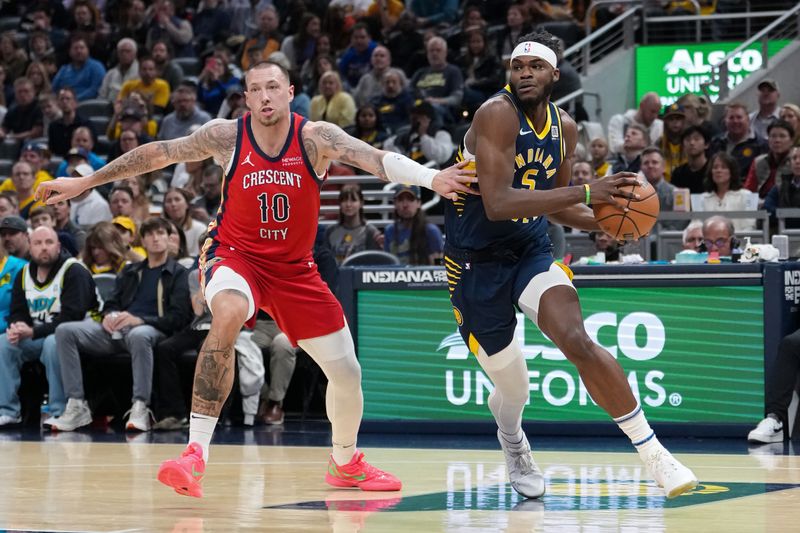 INDIANAPOLIS, INDIANA - NOVEMBER 25: Jarace Walker #5 of the Indiana Pacers dribbles the ball while being guarded by Daniel Theis #10 of the New Orleans Pelicans in the first quarter at Gainbridge Fieldhouse on November 25, 2024 in Indianapolis, Indiana. NOTE TO USER: User expressly acknowledges and agrees that, by downloading and or using this photograph, User is consenting to the terms and conditions of the Getty Images License Agreement. (Photo by Dylan Buell/Getty Images)