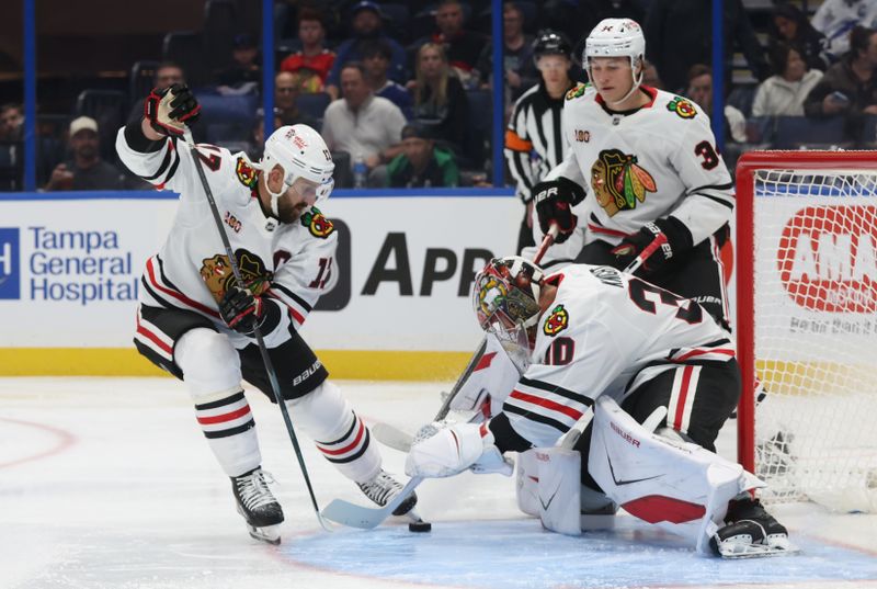 Oct 23, 2025; Tampa, Florida, USA; Chicago Blackhawks goaltender Spencer Knight (30) makes a save during the first period at Benchmark International Arena. Mandatory Credit: Kim Klement Neitzel-Imagn Images