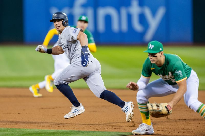 Sep 20, 2024; Oakland, California, USA; New York Yankees shortstop Anthony Volpe (11) runs to second during the third inning against the Oakland Athletics at Oakland-Alameda County Coliseum. Mandatory Credit: Bob Kupbens-Imagn Images