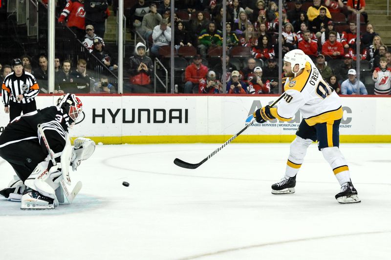 Apr 7, 2024; Newark, New Jersey, USA; Nashville Predators center Ryan O'Reilly (90) takes a shot that is saved by New Jersey Devils goaltender Jake Allen (34) during the overtime shootout at Prudential Center. Mandatory Credit: John Jones-USA TODAY Sports