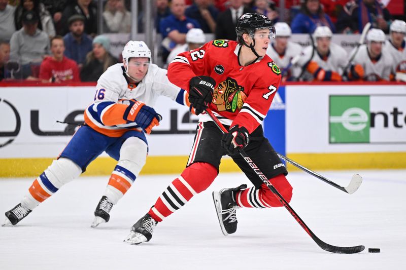 Jan 19, 2024; Chicago, Illinois, USA; Chicago Blackhawks defenseman Alex Vlasic (72) skates the puck away from New York Islanders forward Julien Gauthier (16) in the second period at United Center. Mandatory Credit: Jamie Sabau-USA TODAY Sports