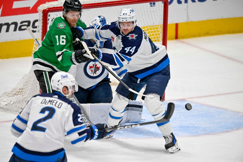 Apr 11, 2024; Dallas, Texas, USA; Dallas Stars center Joe Pavelski (16) and Winnipeg Jets defenseman Josh Morrissey (44) look for the puck during the first period at the American Airlines Center. Mandatory Credit: Jerome Miron-USA TODAY Sports