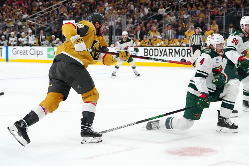 Apr 29, 2025; Las Vegas, Nevada, USA; Minnesota Wild defenseman Jon Merrill (4) blocks a shot by Vegas Golden Knights center Tomas Hertl (48) during the second period of game five of the first round of the 2025 Stanley Cup Playoffs at T-Mobile Arena. Mandatory Credit: Stephen R. Sylvanie-Imagn Images