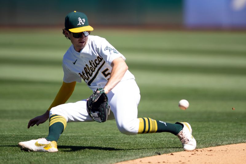 Sep 5, 2024; Oakland, California, USA; Oakland Athletics shortstop Jacob Wilson (5) cannot get a glove on a ground ball by Seattle Mariners right fielder Mitch Haniger during the sixth inning at Oakland-Alameda County Coliseum. Mandatory Credit: D. Ross Cameron-Imagn Images