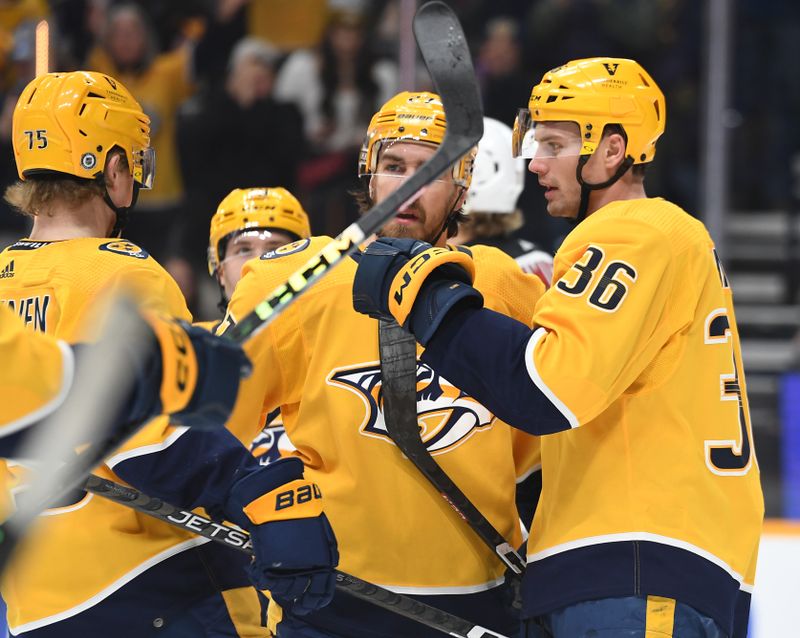 Jan 26, 2023; Nashville, Tennessee, USA; Nashville Predators left wing Cole Smith (36) is congratulated by teammates after a goal during the first period against the New Jersey Devils at Bridgestone Arena. Mandatory Credit: Christopher Hanewinckel-USA TODAY Sports