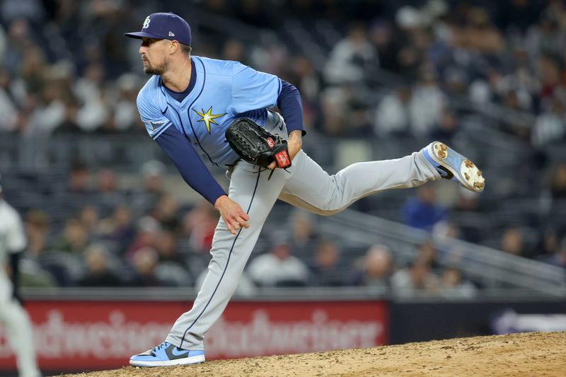 Apr 19, 2024; Bronx, New York, USA; Tampa Bay Rays relief pitcher Shawn Armstrong (64) follows through on a pitch against the New York Yankees during the sixth inning at Yankee Stadium. Mandatory Credit: Brad Penner-USA TODAY Sports