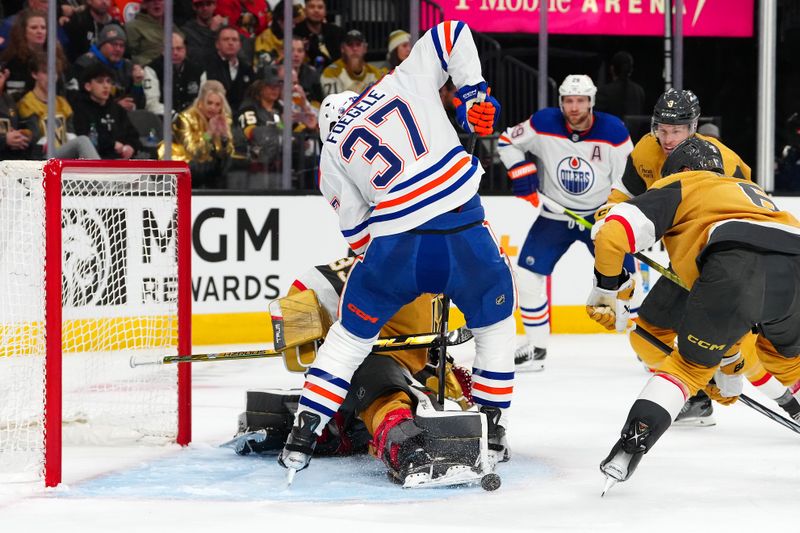 Feb 6, 2024; Las Vegas, Nevada, USA; Vegas Golden Knights goaltender Adin Hill (33) makes a skate save between the legs of Edmonton Oilers left wing Warren Foegele (37) during the second period at T-Mobile Arena. Mandatory Credit: Stephen R. Sylvanie-USA TODAY Sports