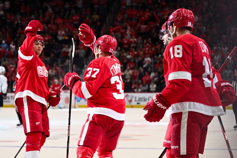 Feb 27, 2024; Detroit, Michigan, USA; Detroit Red Wings left wing J.T. Compher (37) celebrates his goal with defenseman Moritz Seider (53) and center Andrew Copp (18) during the second period against the Washington Capitals at Little Caesars Arena. Mandatory Credit: Tim Fuller-USA TODAY Sports