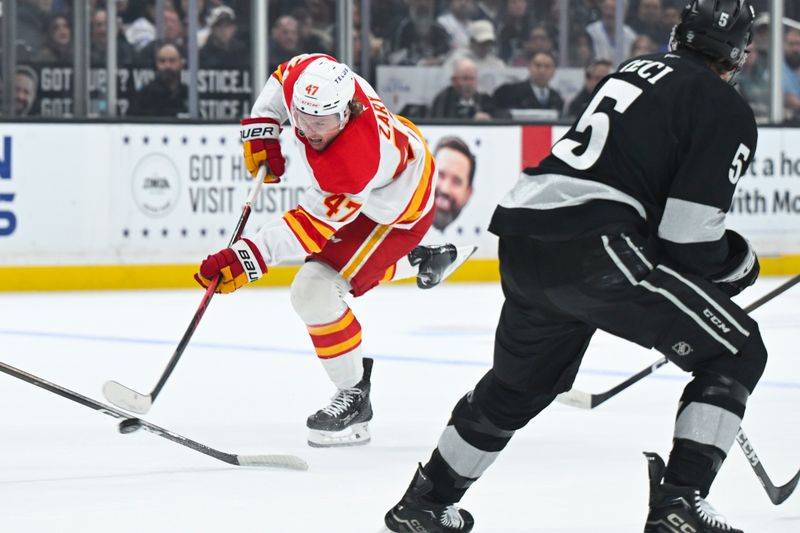 Feb 28, 2026; Los Angeles, California, USA; Calgary Flames center Connor Zary (47) shoots the puck during the first period against the Los Angeles Kings at Crypto.com Arena. Mandatory Credit: Griffin Hooper-Imagn Images